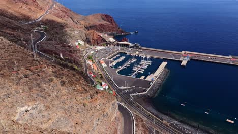 stunning coastal port on el hierro, surrounded by rugged mountains, ocean, drone