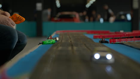 watching bmw scalextric scale race track competition at barcelona car show