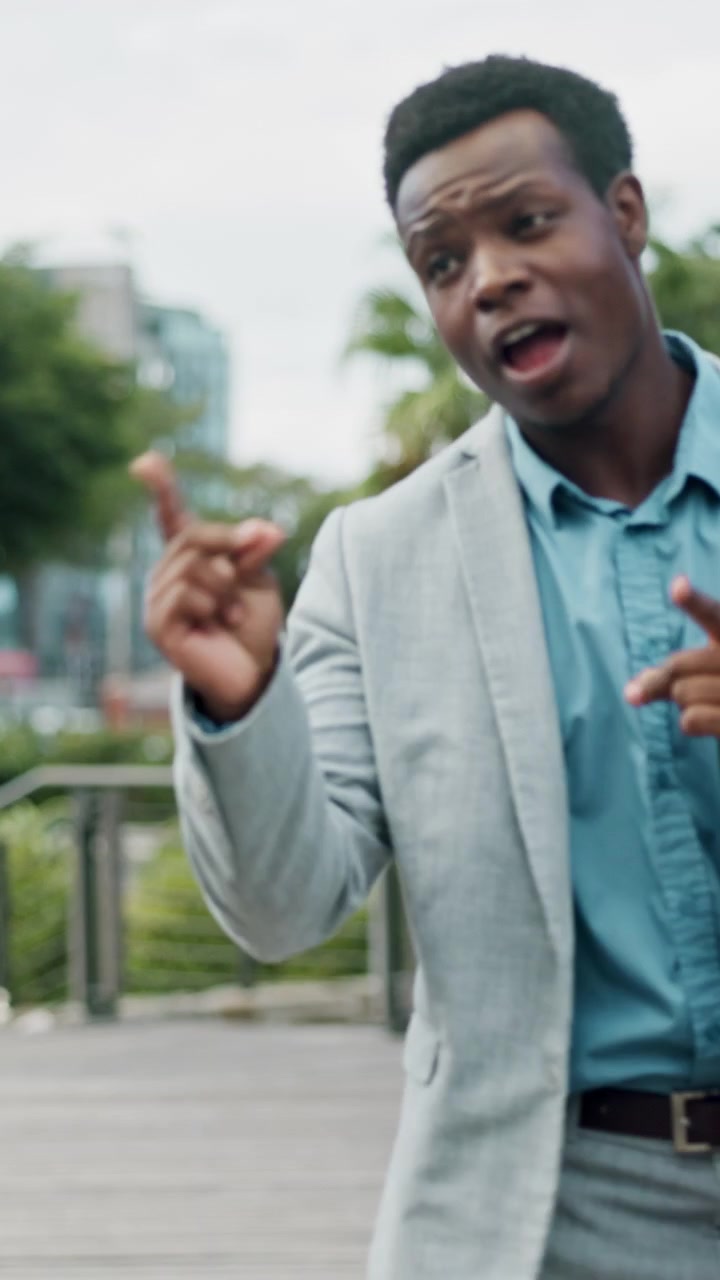 Young Businessman Walking and Talking Outdoors in City