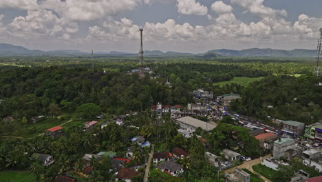 Ibbagamuwa-Sri-Lanka-Aerial-v2-drone-flyover-village-town-captures-local-community-along-Dambulla-road,-surrounded-by-lush-jungle,-mountains,-and-farming-fields---Shot-with-Mavic-3-Cine---April-2023