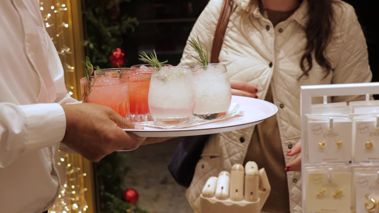 Waiter Serving Cocktails to a Woman
