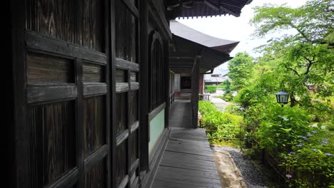 Walk-along-Ryotonji-Temple's-wall-with-garden-views-in-city-of-Hamamatsu,-Japan