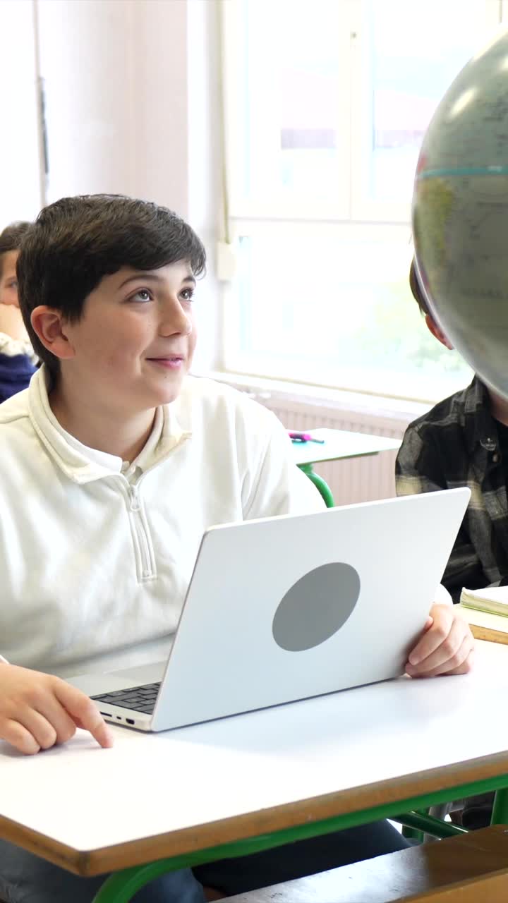 Student learning with laptop in classroom