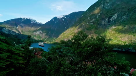 Luftaufnahme-Von-Flam-Dorf-Norwegen-Fjord-Ufer-Kreuzfahrtschiff-Berge-Tal-Schnee-Gipfel