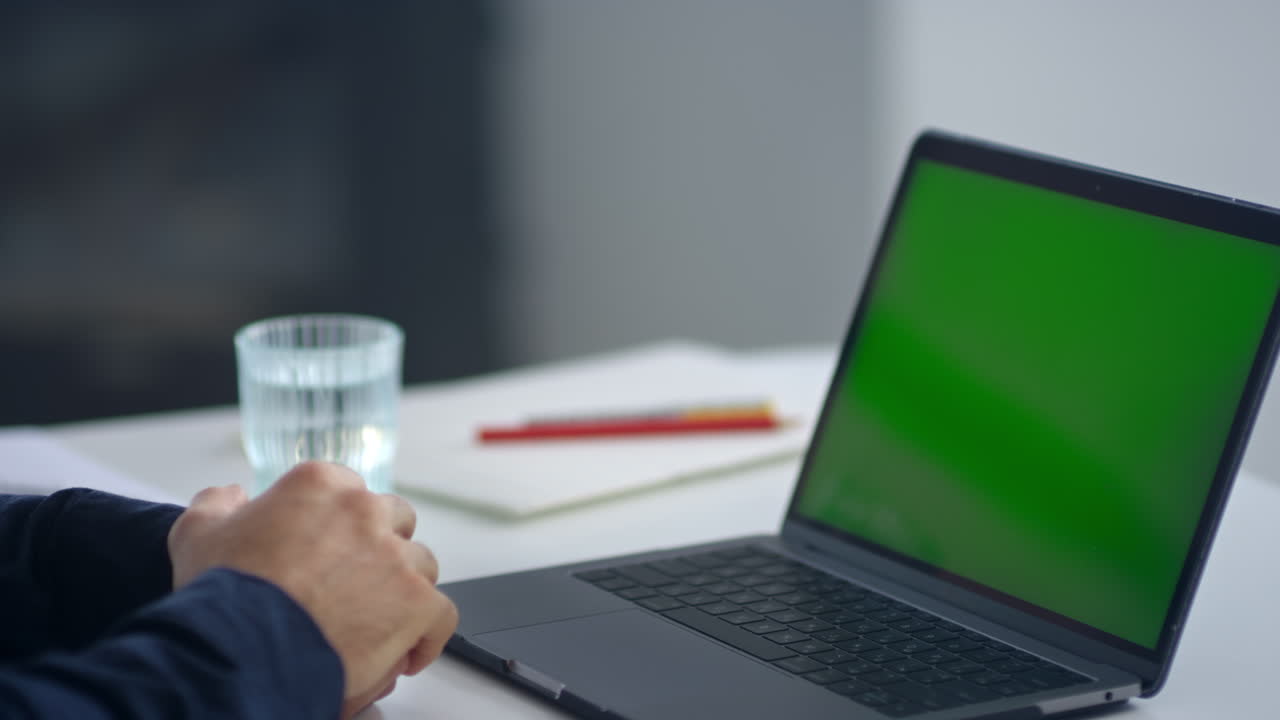 Business man looking green screen laptop. Man waving hand after video call.