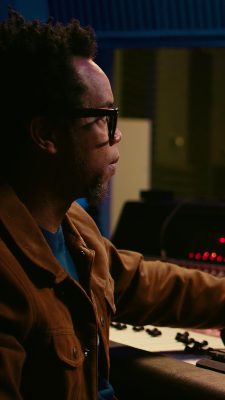 Focused Musician Working on Sound Mixer in Recording Studio