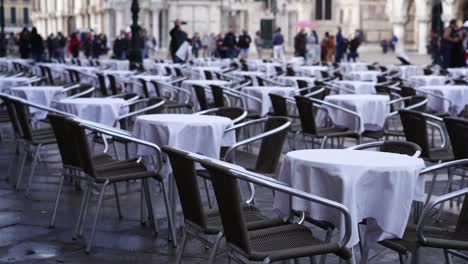 lines of tables and chairs of outdoor restaurant in venice