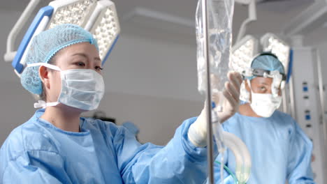 diverse female surgeons operating on patient in operating theatre, slow motion