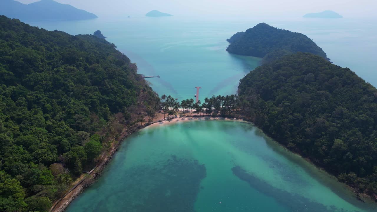 Scenic aerial view of lush green hills and turquoise waters on Koh Chang Ngam Island. Nice aerial view flight drone shot footage from above