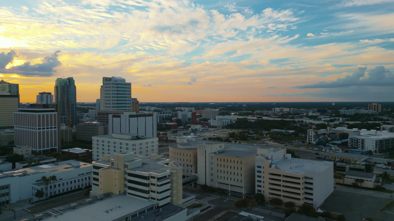 Panning across the downtown Tampa skyline as the day ends and sunset begins with golden light reflecting off of buildings