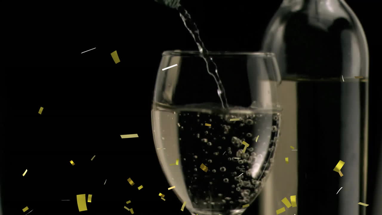 Animation of confetti over glass of white wine on black background