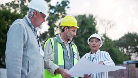 construction workers discussing blueprints on site