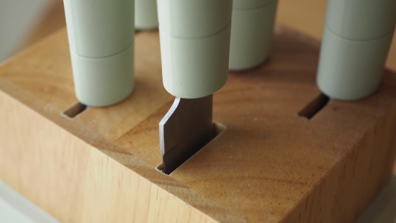 Close up of knives in a wooden block