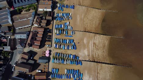 An-birds-eye-view-of-the-Whitstable-beach,-with-the-tide-out-showing-yachts-under-covers