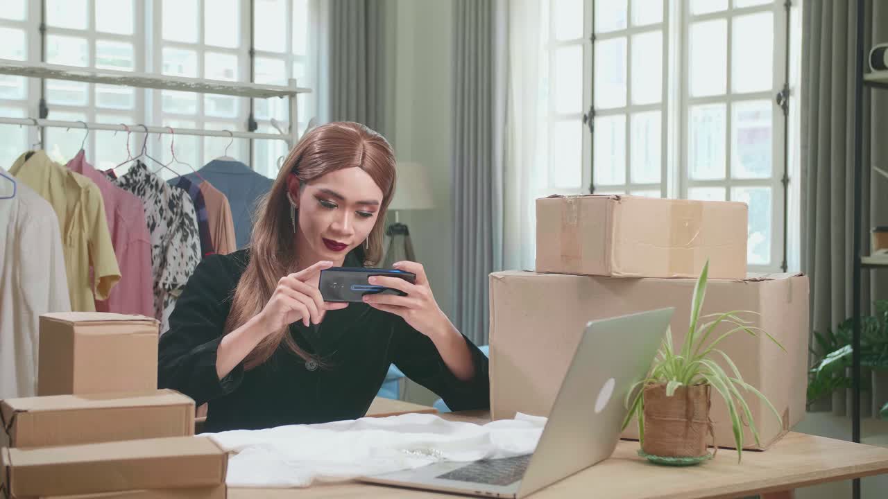 Young Asian Transgender Woman Business Owner With Boxes On The Table Happy Online Sales Job, Get An Order From Customers, Take Photos Of Product For Send To Customers
