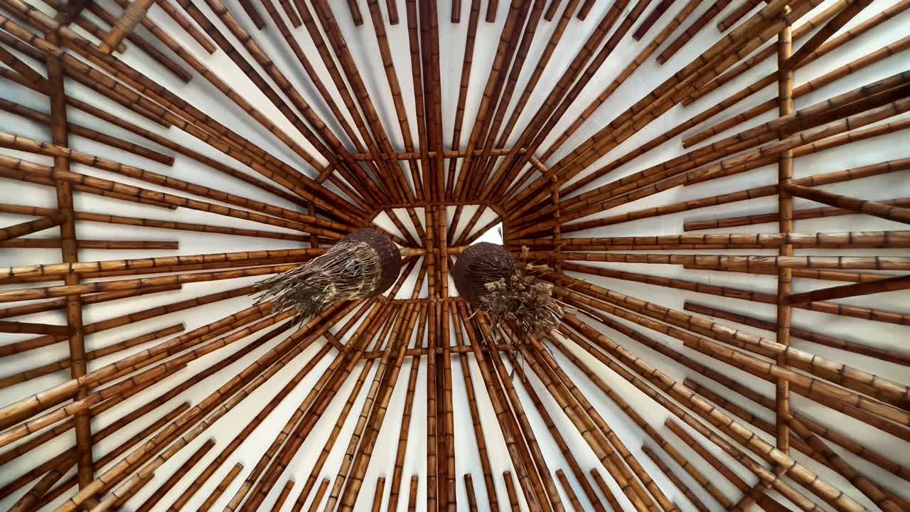 Inside pagoda tilt up view to reveal ornate bamboo roof supports