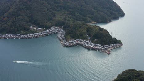 Fishing-Boat-Entering-Ine-Port-and-Sailing-Past-Fisherman-Houses,-Kyoto-Japan