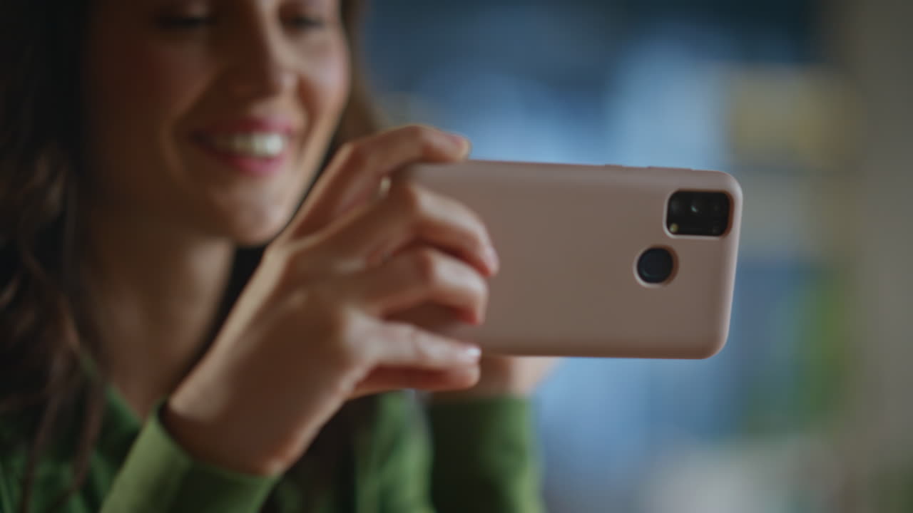 Smiling woman looking phone in office closeup. Happy lady watching smartphone