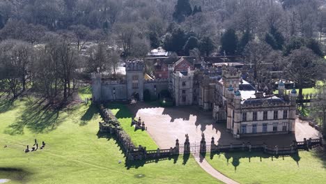 knebworth house, showcasing the grand architecture and green lawn., aerial view