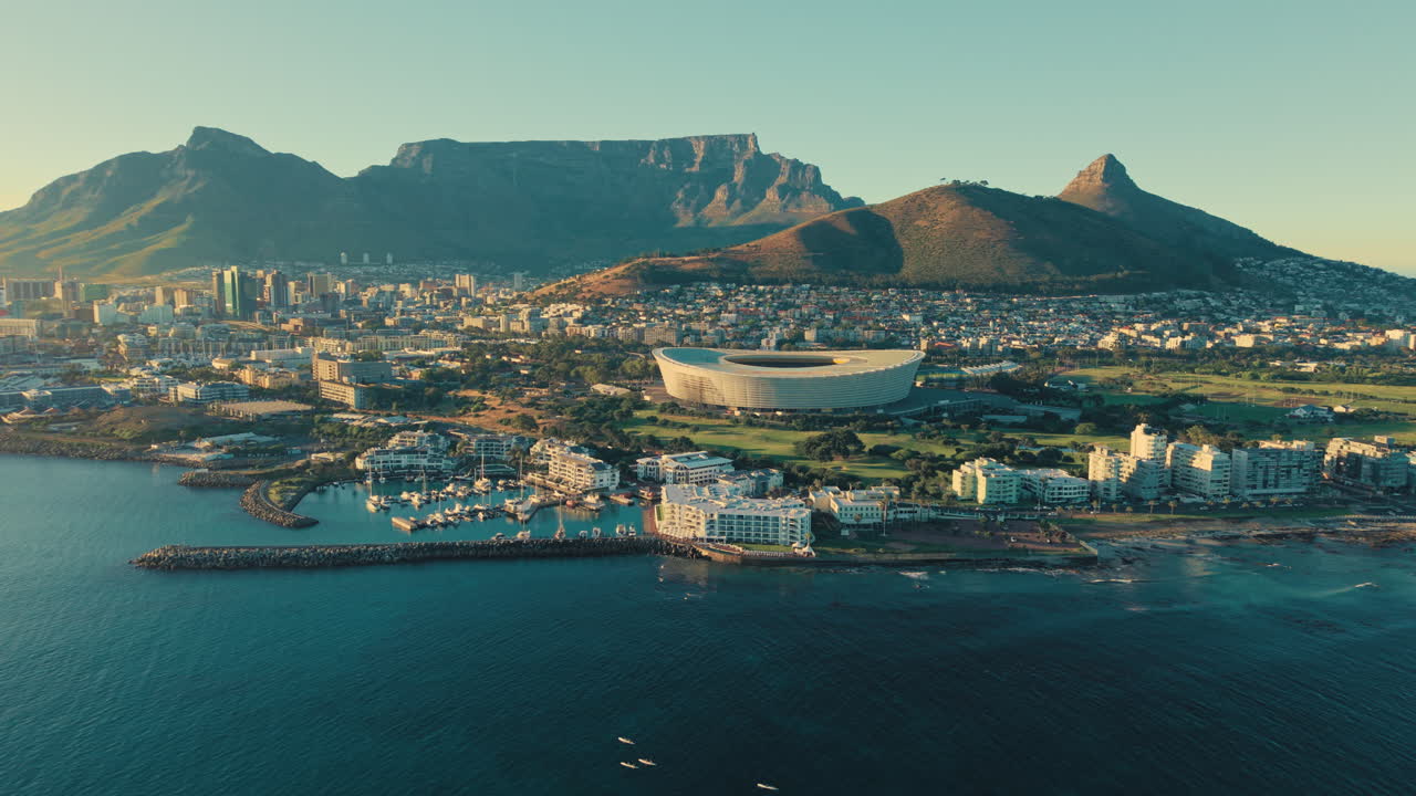Cape Town coastline golden light aerial shot with panoramic views over the city, Table Mountain, Lion's Head and the Waterfront