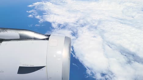 airplane flies into wall of clouds while surrounded by blue skyes