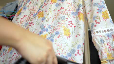 Closeup-of-a-woman-ironing-clothing-by-stream-iron-on-board-at-home-with-slow-motion-scene