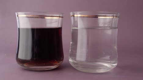 comparing soft drinks with glass of water on table