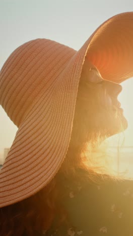 woman wearing a straw hat enjoying the sun