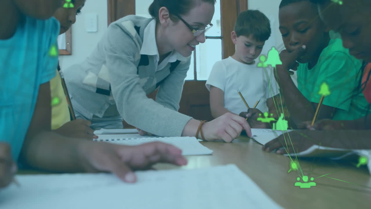Teacher helping diverse students with homework, animation of green network icons in school