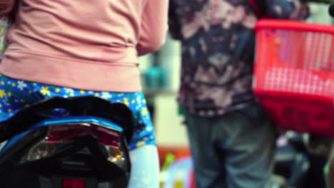 vietnamese fashion of scooter drivers, handheld back view
