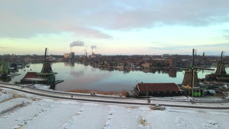 Dawn-at-Dutch-windmills-with-industrial-ovens-in-background,-town-of-Zaandijk