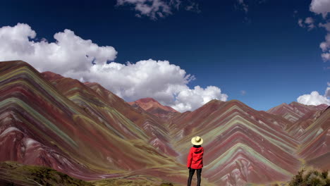person admiring the vibrant rainbow mountain landscape in peru