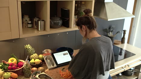 Young-Woman-On-Phone-Whilst-Reading-a-Recipe