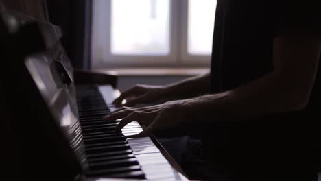 close-up of pianist's hands practicing to play the piano at home