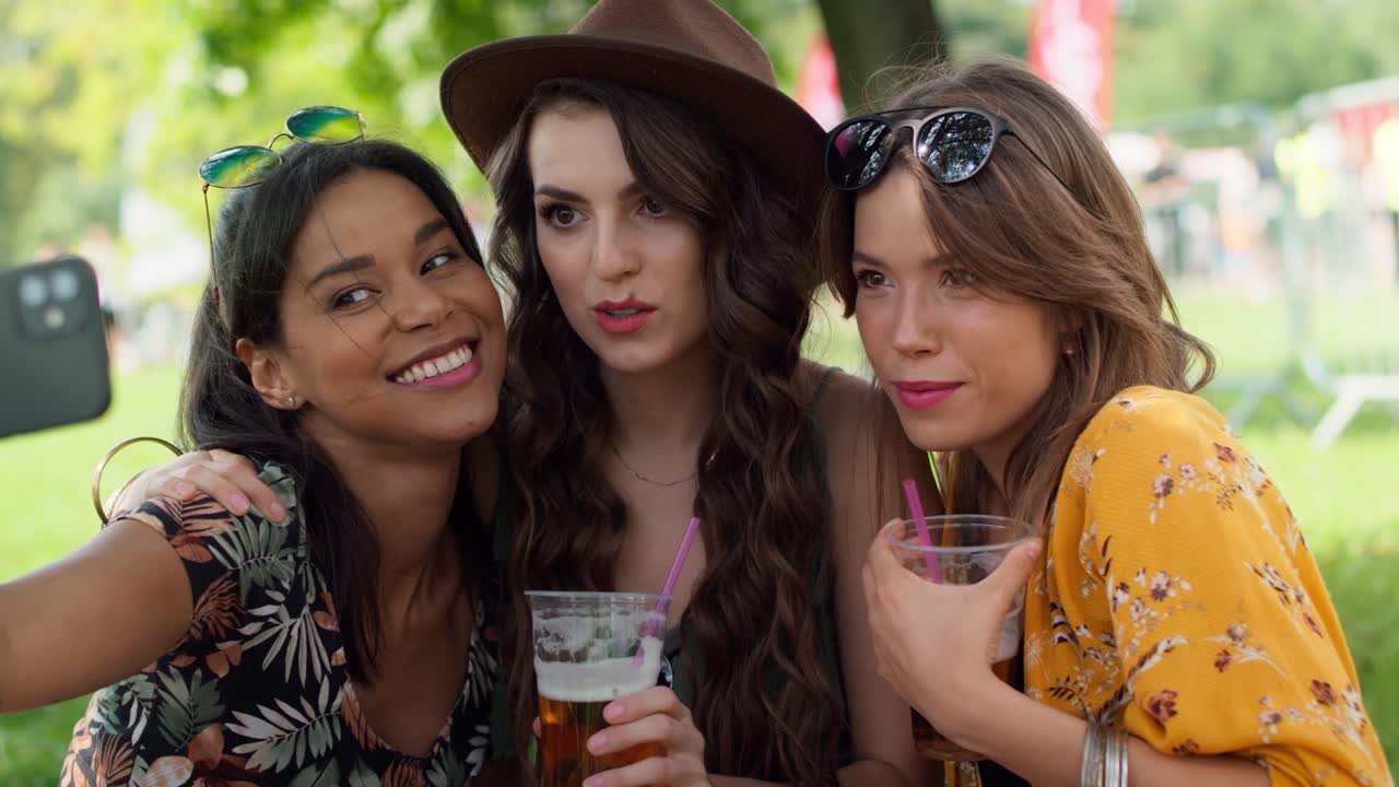 Group of friends making selfie at music festival