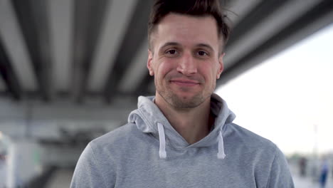 handsome man looking at camera smiling and laughing with sportswear