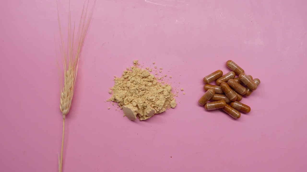 Wheat Stalk, Powder, and Capsules Representing Natural Supplements