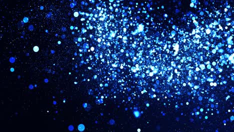 illuminated blue and white particles floating on a black background