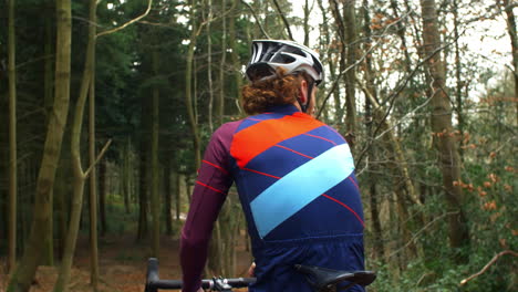 ciclista de cross-country descansando e bebendo em bicicleta, vista de trás, filmado em r3d