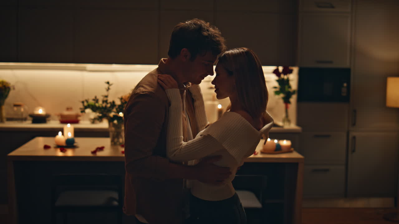 Passionate couple dancing home kitchen close up. Happy lovers moving slowly