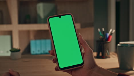 fingers zooming mockup cellphone at dark home office closeup. hands holding