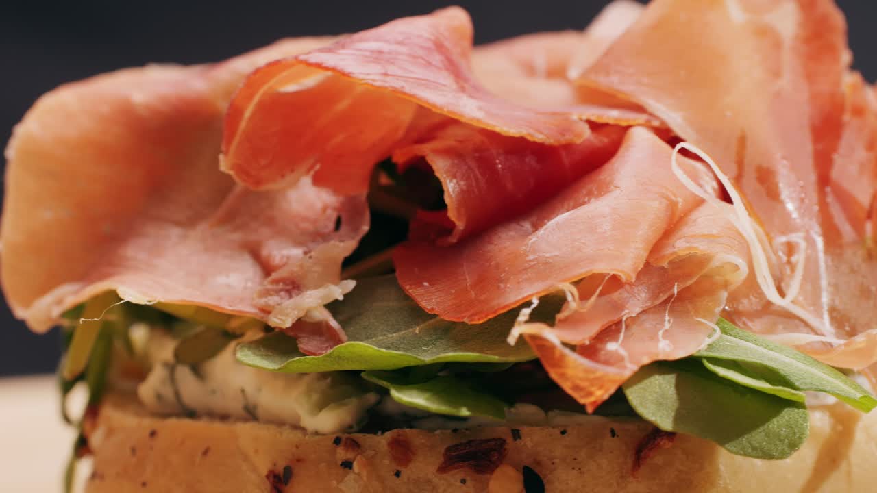 Bagel sandwich brunch, lunch plate of a bagel with smoked salmon and cream cheese and ham, close up morning cafe menu.