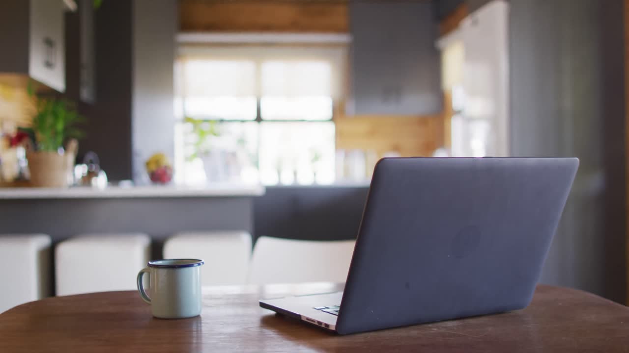 Empty room in log cabin with laptop and mug on table, slow motion