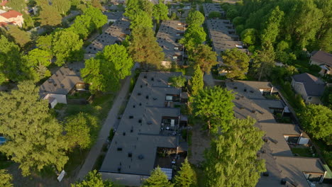 Aerial-tracking-shot-of-rowhouses,-summer-evening-in-the-suburbs-of-Helsinki