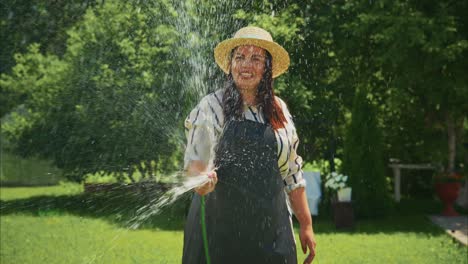 woman in straw hat watering plants in a lush garden, showcasing vibrant greenery and joyful atmosphere