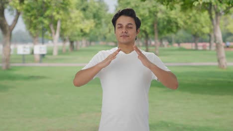 happy indian man doing breathe in breathe out exercise