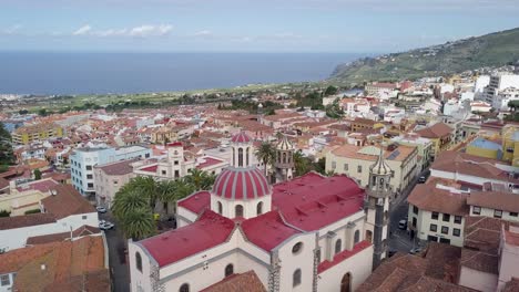 aerial-footage-of-puerto-De-la-Cruz-in-tenerife-island-spain-,-drone-fly-above-ancient-old-medieval-town-on-the-ocean-coastline