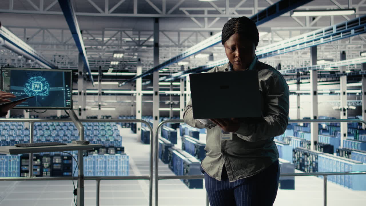 Data Center Admin Checks Ai Dashboard Using Laptop During Rigs Systems Review