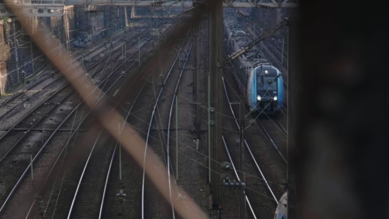 Trains crossing path at a railroad station in slow-motion in Paris