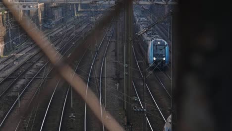 trains crossing path at a railroad station in slow-motion in paris